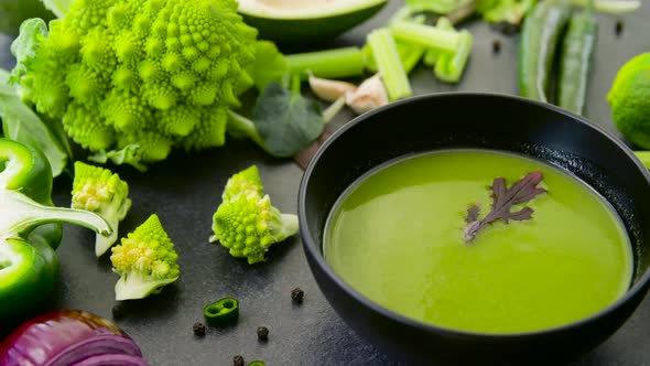 Green Cream Soup in Bowl and Vegetables 