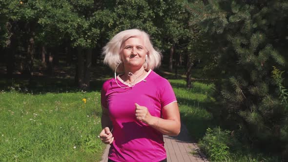 Senior sportive woman jogging in the park.