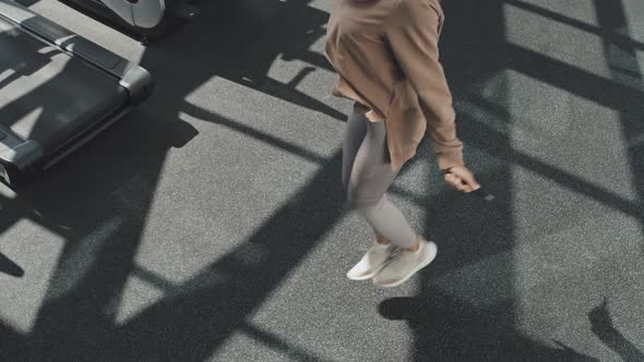 Woman in Hijab Jumping Rope in Gym