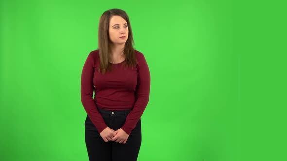 Angry Girl Is Scolding and Threatening with a Fist. Green Screen