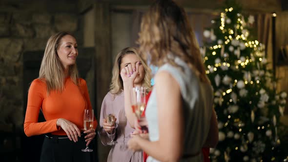 Merry Party in Christmas Vacation Women are Celebrating New Year Drinking Champagne