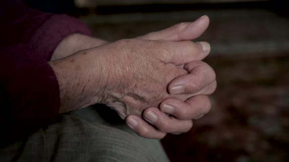 Close Up Of Elderly Old Hands Shaking From Nervous Tic Or Tremor