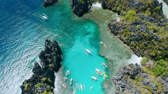 Aerial Top Down View of Tourist Boat Arriving Into the Small Lagoon in ElNido Tour A Palawan