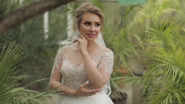 Beautiful and Lovely Bride in Wedding Dress in the Park. Slow Motion