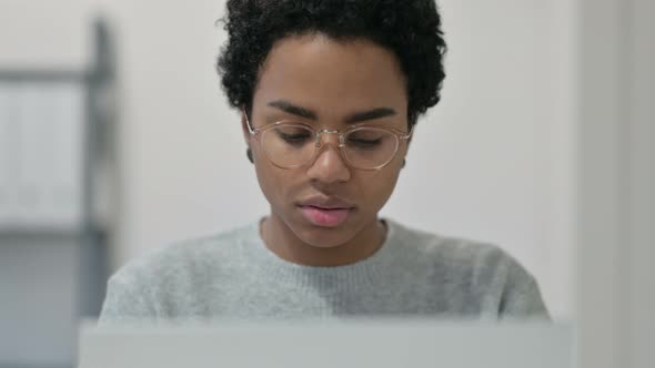 Portrait of African Woman with Laptop Smiling at Camera