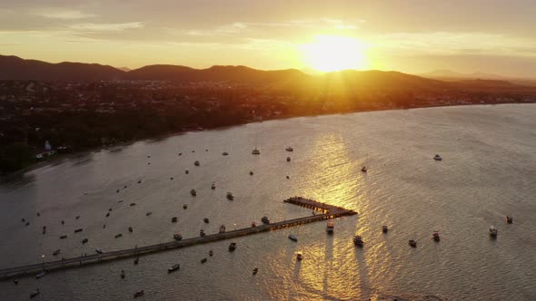 Aerial view of sunset in Buzios bay with boast, Brazil