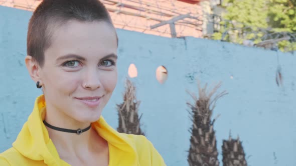  Portrait of Young Woman with Shaved Hair in Street Urban Background