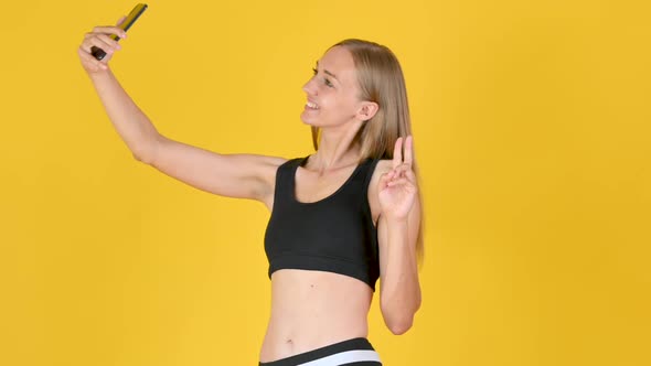Smiling fit girl taking selfie after sports exercise