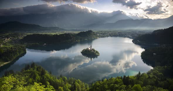 Lake Bled island landscape timelapse in Slovenia. Time lapse of clouds over Julian Alps Mountains Ra