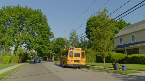 Yellow School Bus Drives Away from Suburban House in Roslyn Long Island