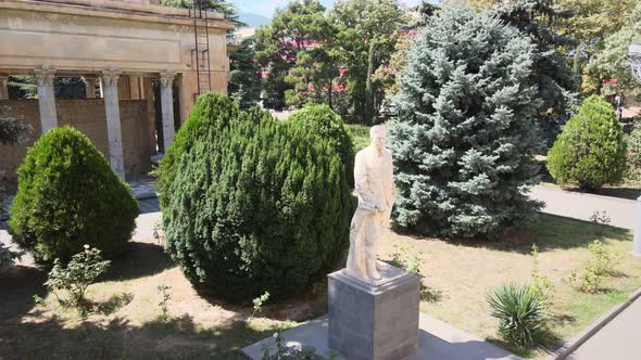 Flying over the Monument of Joseph Stalin in front of the Joseph Stalin Museum in city Gori