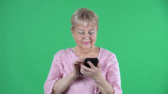 Portrait Elderly Woman Texting on Her Smartphone