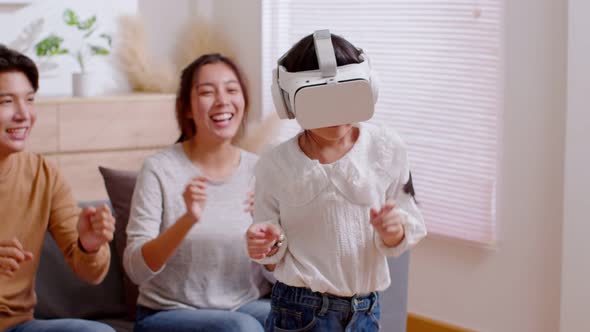 Happy Asian family spending time together. Father and mother cheer up their child to dance while wea