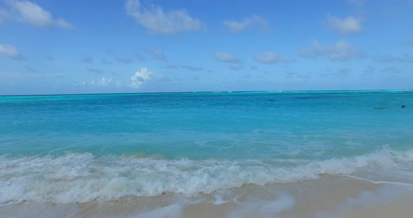 Tropical overhead tourism shot of a summer white paradise sand beach and blue ocean background in be