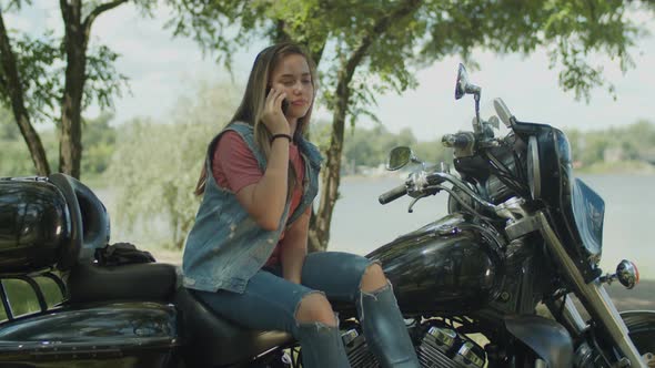 Chatting on Phone Cute Girl Sitting on Motorbike