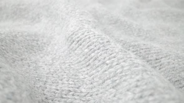 Extreme detail view of sheep wool cloth texture flowing in macro dolly shot.