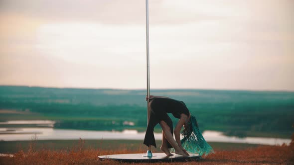 Woman with Blue Braids Dancing By the Pole - Bending Down