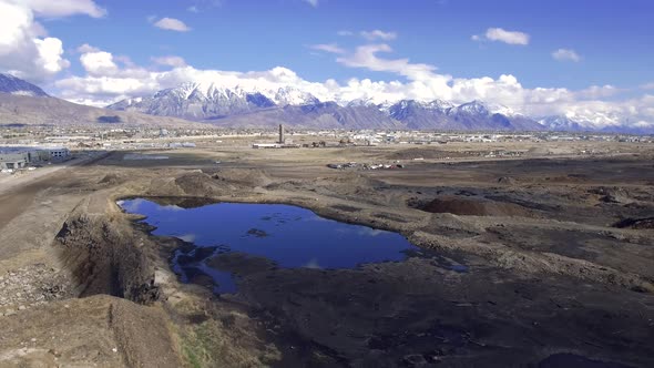 The snow-capped Wasatch Mountains and Mount Timpanogos rise above Utah County as a drone flies over