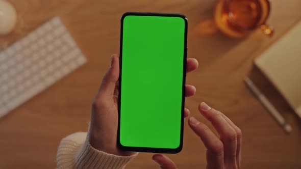 Top View of Woman Using Smartphone with Green Screen