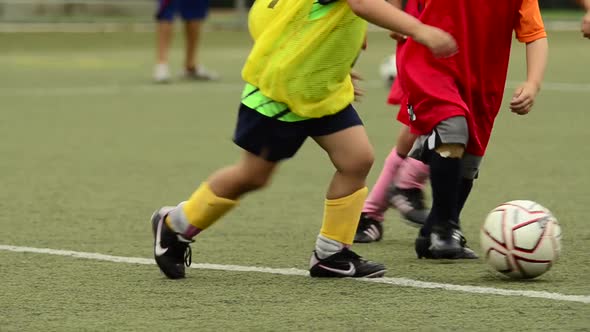 Children ages 5-7 playing soccer/ football.