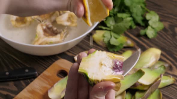 Woman Cleaning Artichokes