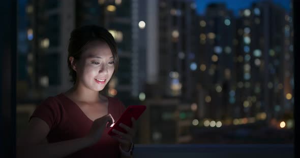 Woman Work on Mobile Phone with Building Background in City