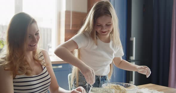 Mother and Daughter Baking Cooking Together in the Kitchen at Home