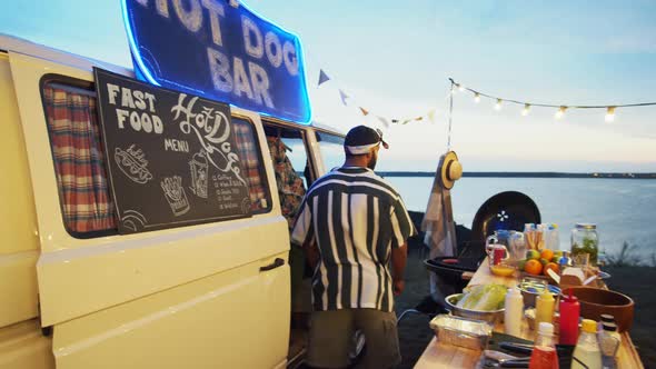 Man Turning on Lights and Start Selling Street Food at Truck