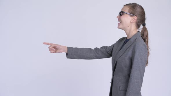 Profile View of Young Happy Businesswoman Pointing Finger
