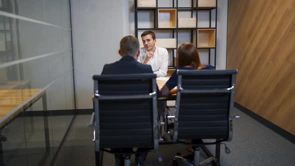 Family with Realtor in Boardroom Discussing About Mortgage Contract.