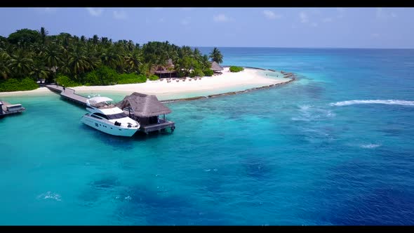 Aerial above scenery of relaxing seashore beach time by clear water with white sandy background of a