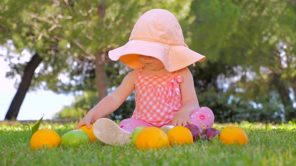 Child Sitting on Green Grass