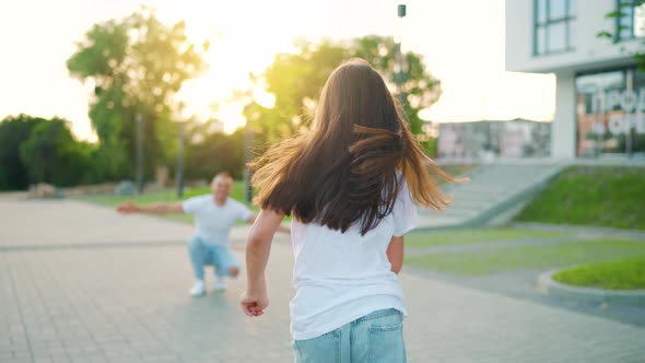 Daughter Runs to Dad and Hugs Him