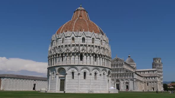 Pisa Baptistery and the famous leaning tower in the back, Italy