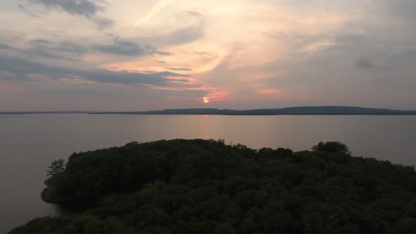 Pretty sunset seen over a forest with slow drone gliding motion