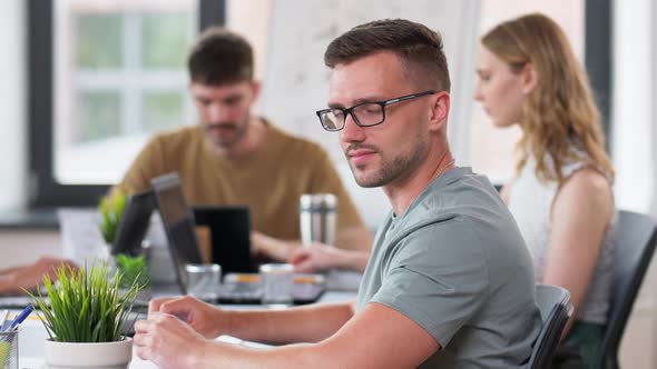 Businessman with Colleagues Working at Office