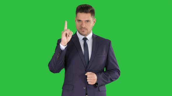 Business man pointing up finger making an accent on a Green