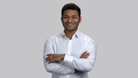 Happy Young Hindu Man with Crossed Arms Showing Thumb Up