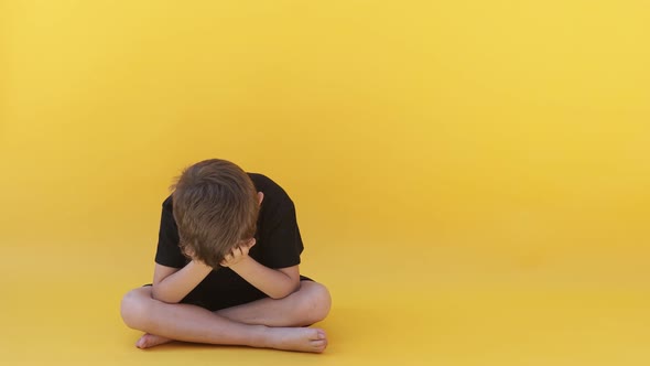 child whose depression is sitting on the color floor