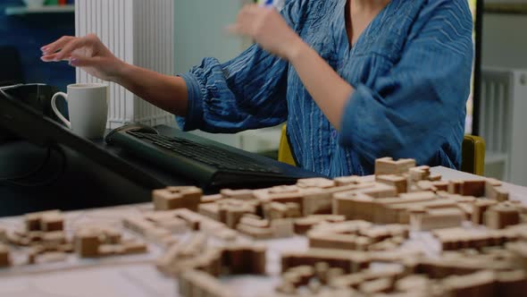 Close Up of Architectural Desk with Building Model and Computer