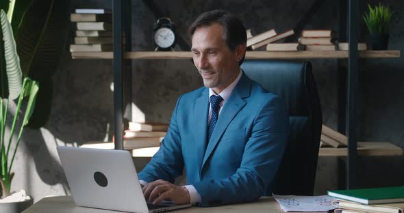 Mature Businessman Adult Employer Working at Laptop Computer in Office Room