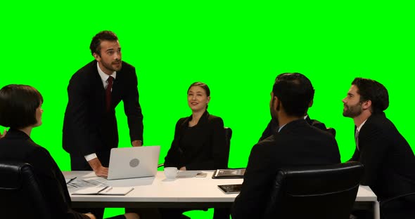 Businessman touching invisible screen while using laptop