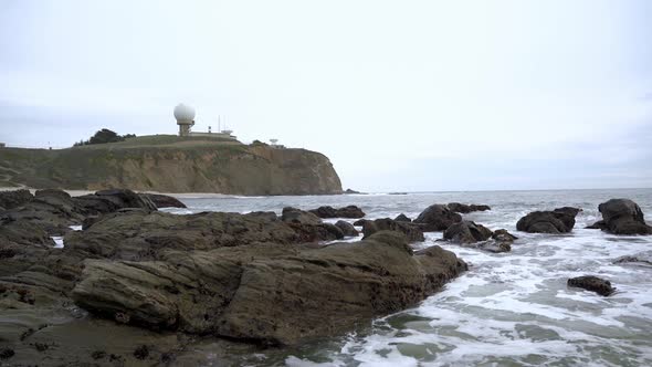 Waves crashing onto rocks and view of the Pillar Point in Half Moon Bay, California