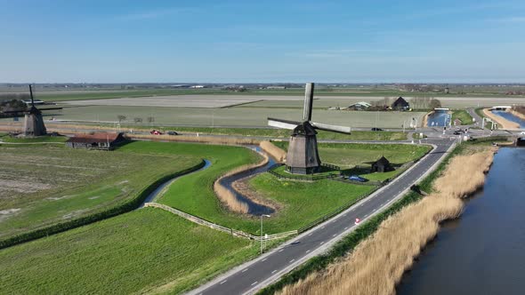 Historic Dutch Windmills in a Farm and Grass Field Landscape in The Netherlands Holland