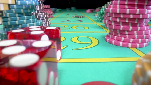 Camera Pans Over Green Gaming Table with Stacks of Casino Chips on a Black Background