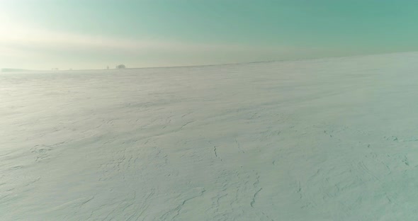 Aerial View of Cold Winter Landscape Arctic Field Trees Covered with Frost Snow Ice River and Sun