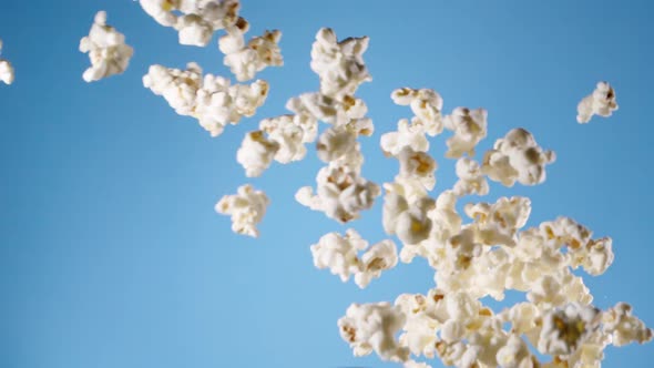 Popcorn flying in slow motion on blue background