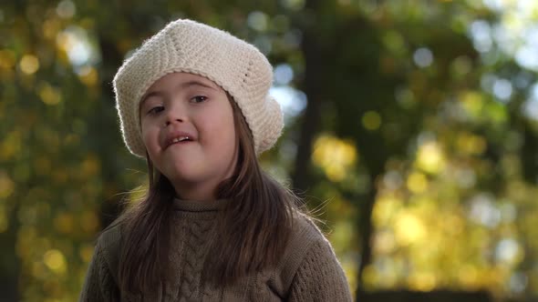 Portrait of Happy Girl with Down Syndrome Outdoors