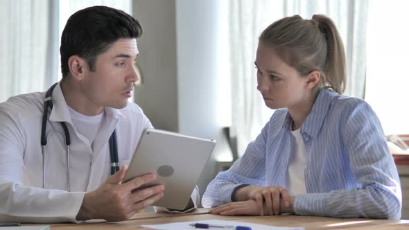 Doctor Sharing Information on Tablet with Patient