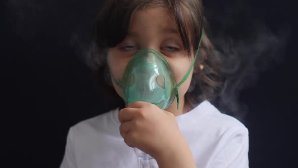 Boy Child Breathes Inhalation Through a Mask is Treated for Allergies